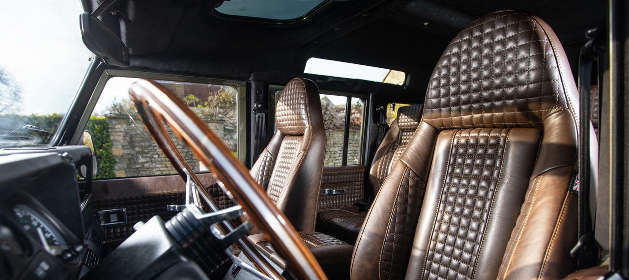 Brown modular Defender seats with chocolate box stitching