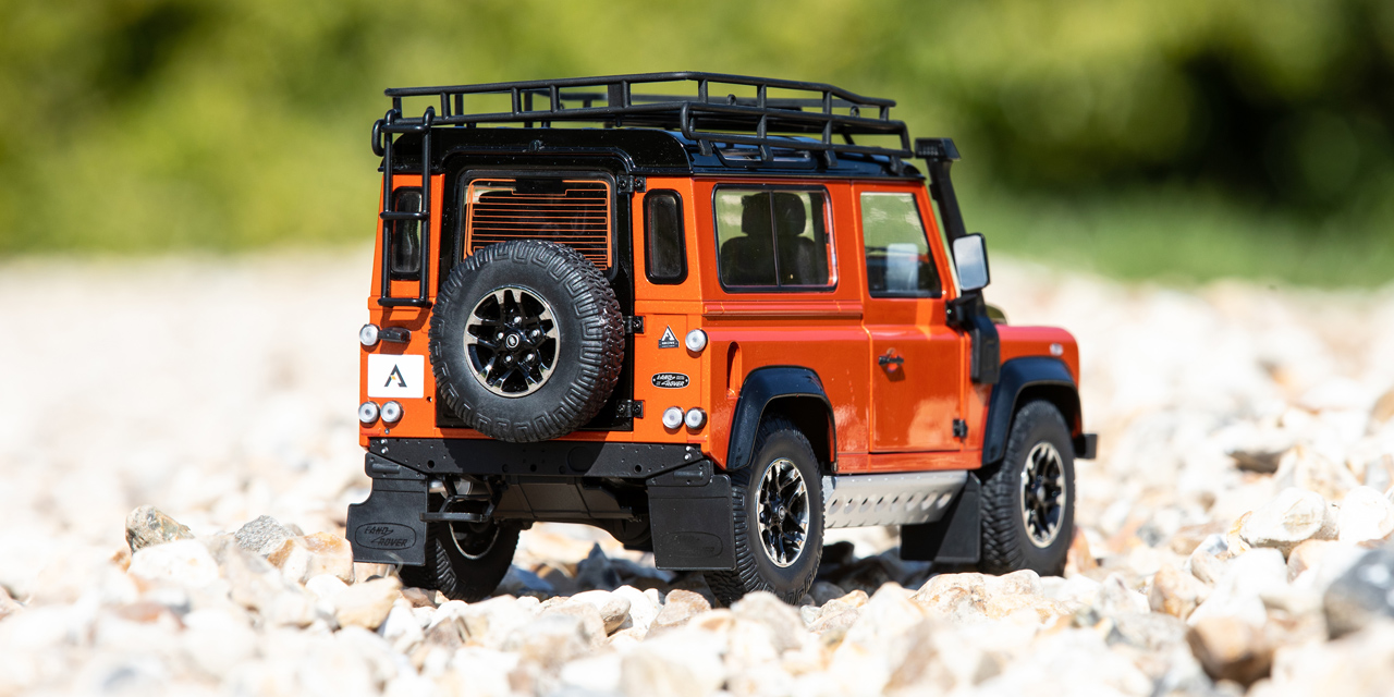 Rear view of a small orange and black model Defender