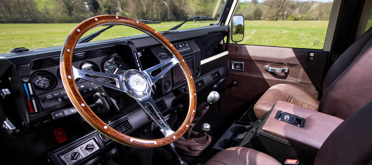 Wooden steering wheel inside a custom Arkonik Defender 110