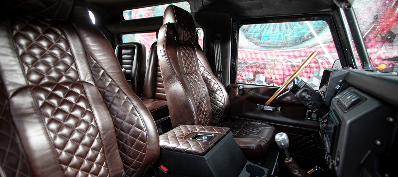 Interior front seats of Defender 90 in brown leather