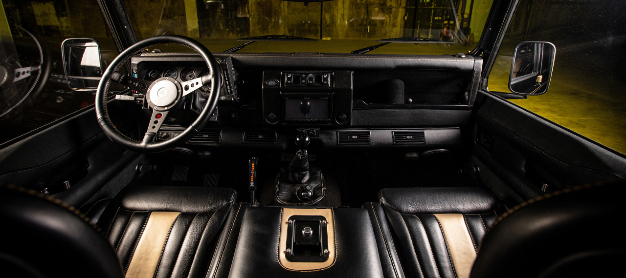 Black and gold leather interior of a Defender 110