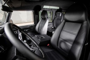 Land Rover Defender interior showing black leather front seats