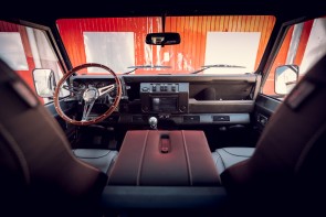 View out of front windscreen of a Defender looking out at re factory doors.