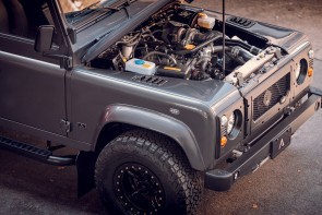 Side view of Defender with the hood open showing engine bay with 200Tdi engine.