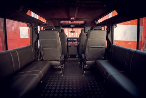 Rear view of Defender 110 with black leather upholstery and suede headlining.