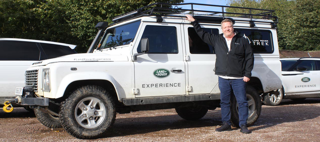 An Arkonik client next to a Land Rover Defender at Eastnor Castle.