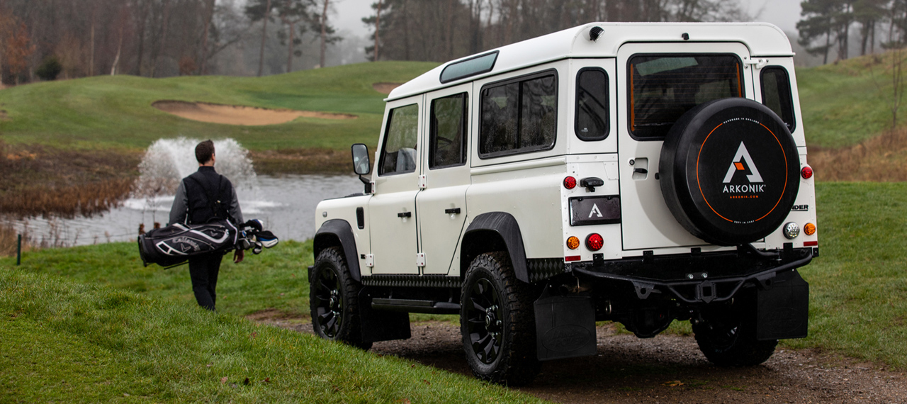 Rear view of D110 with golfer walking beside