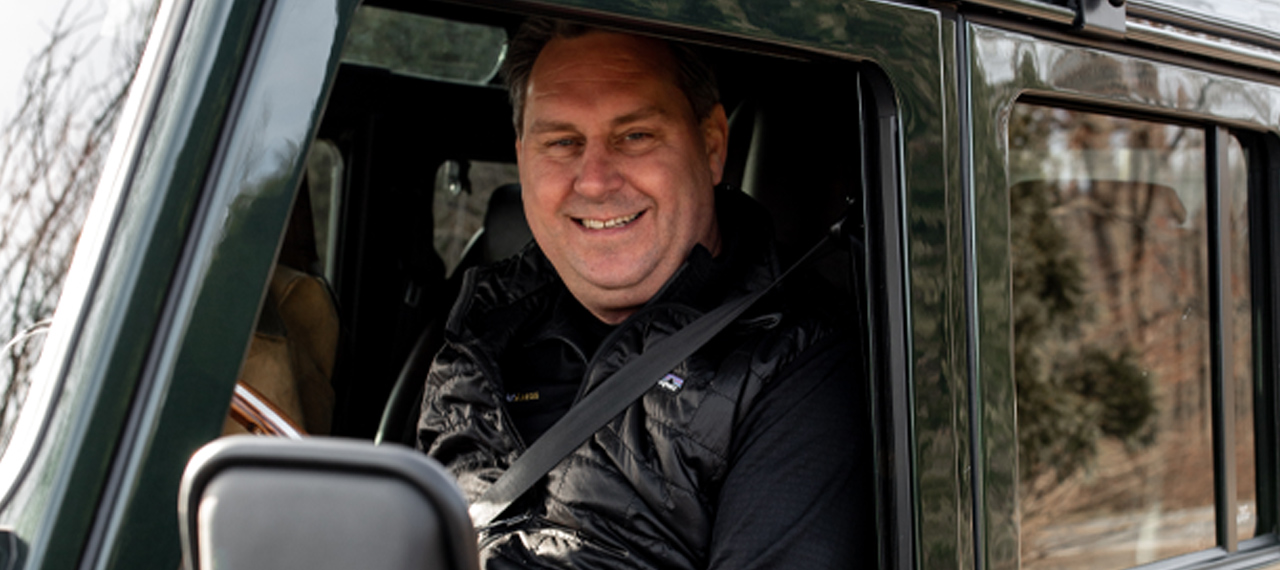 Arkonik client sitting in the front seat of his new Defender 110
