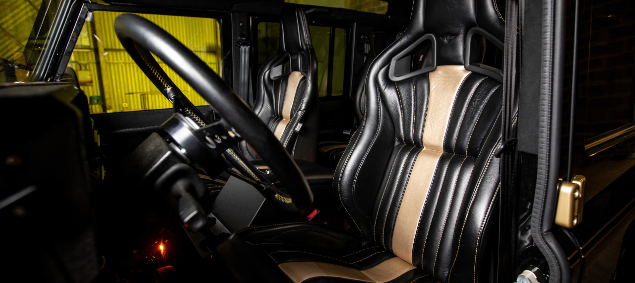 DECADE Defender 110 interior with black and gold leather RECARO seats