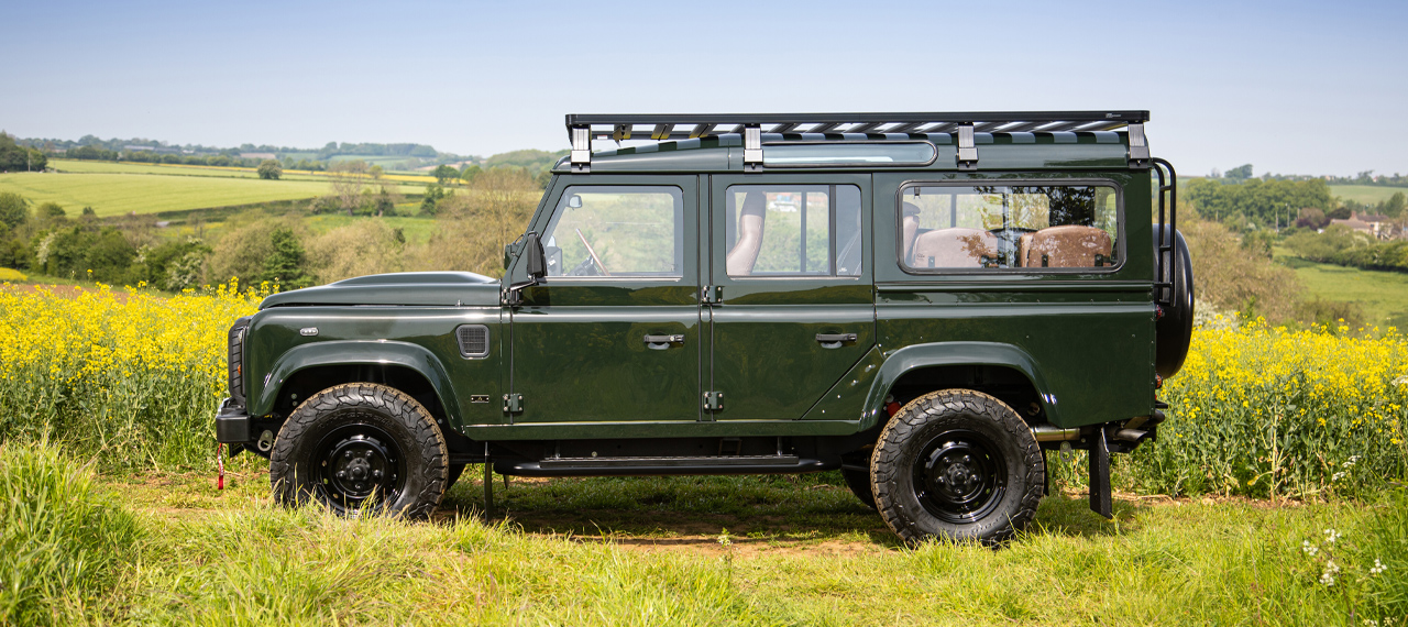 Side view of OMEGA Defender 110 in rapeseed field