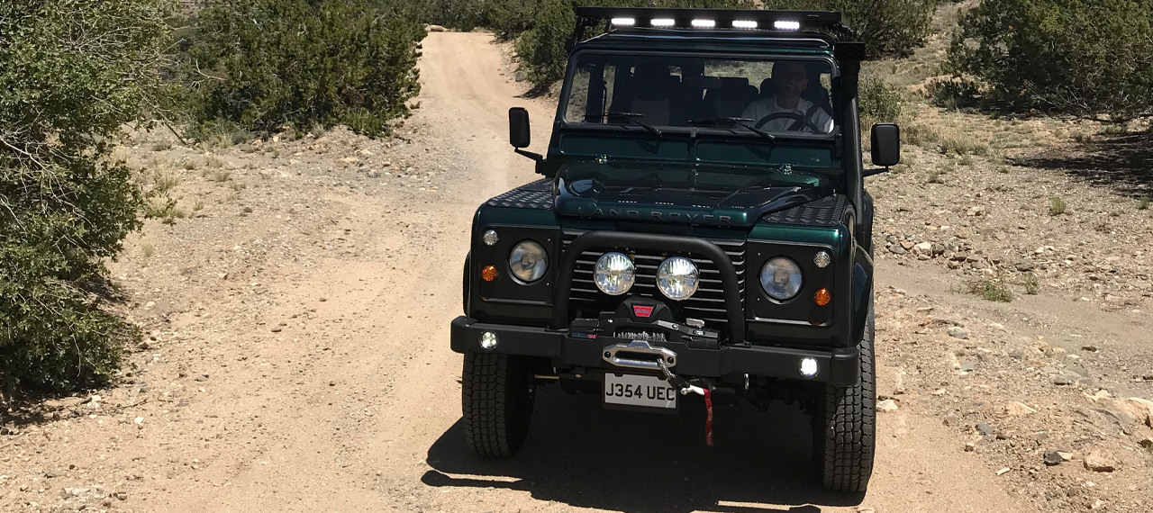 Front view of Navajo Defender 110 being driven off-road